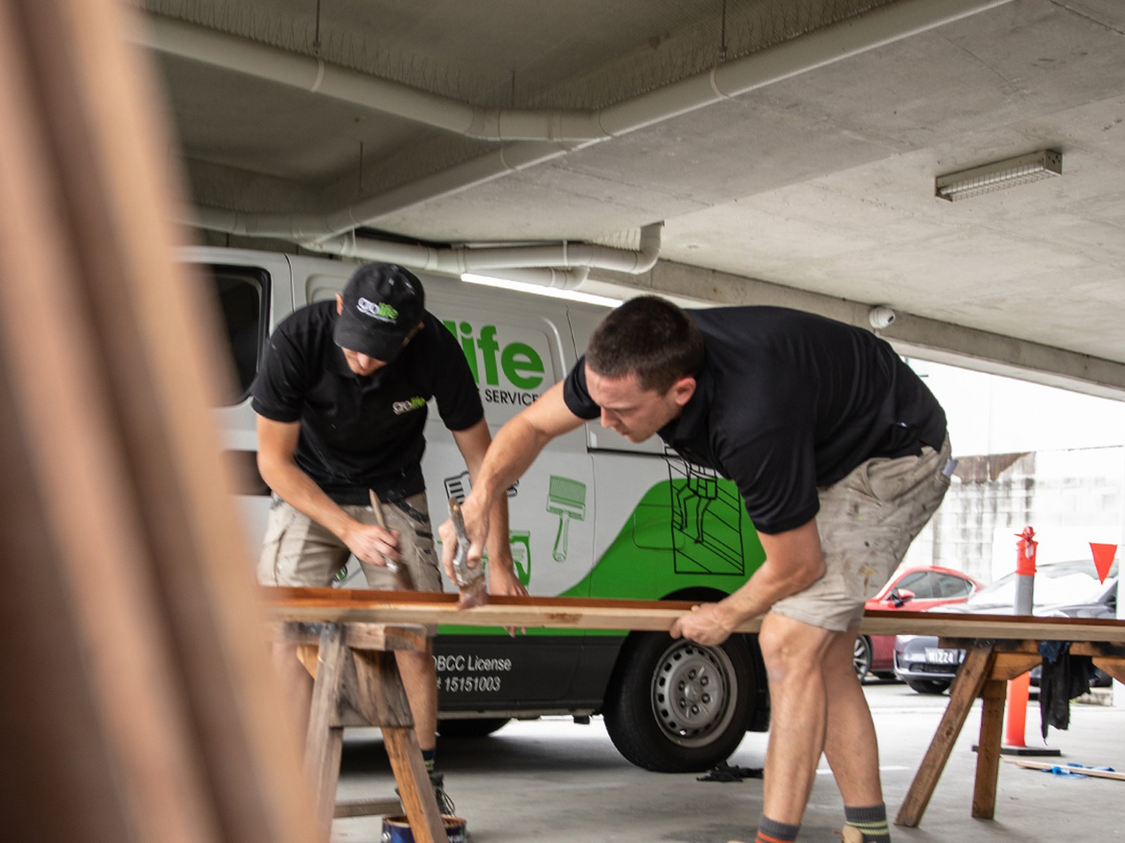 Grolife Property Services crew working alongside a branded service van
